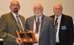 Graham Esler, centre, receives the Paul Fiocca Award from committee members Bret Evans, left, and Charles Moore