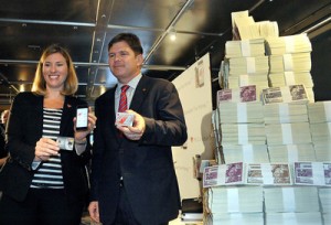 Canadian Tire's Carol Deacon, SVP of Loyalty and Digital, left, and COO Allan MacDonald unveil the new e-Money during a news conference held in a bank vault in Toronto.
