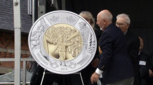 Warren "Whitey" Bernard, the boy in the infamous photograph, unveils the new $2 circulating coin at a ceremony in Westminster, B.C., on Saturday. A stamp and statue were also unveiled.
